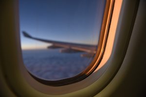Passenger looking out airplane window